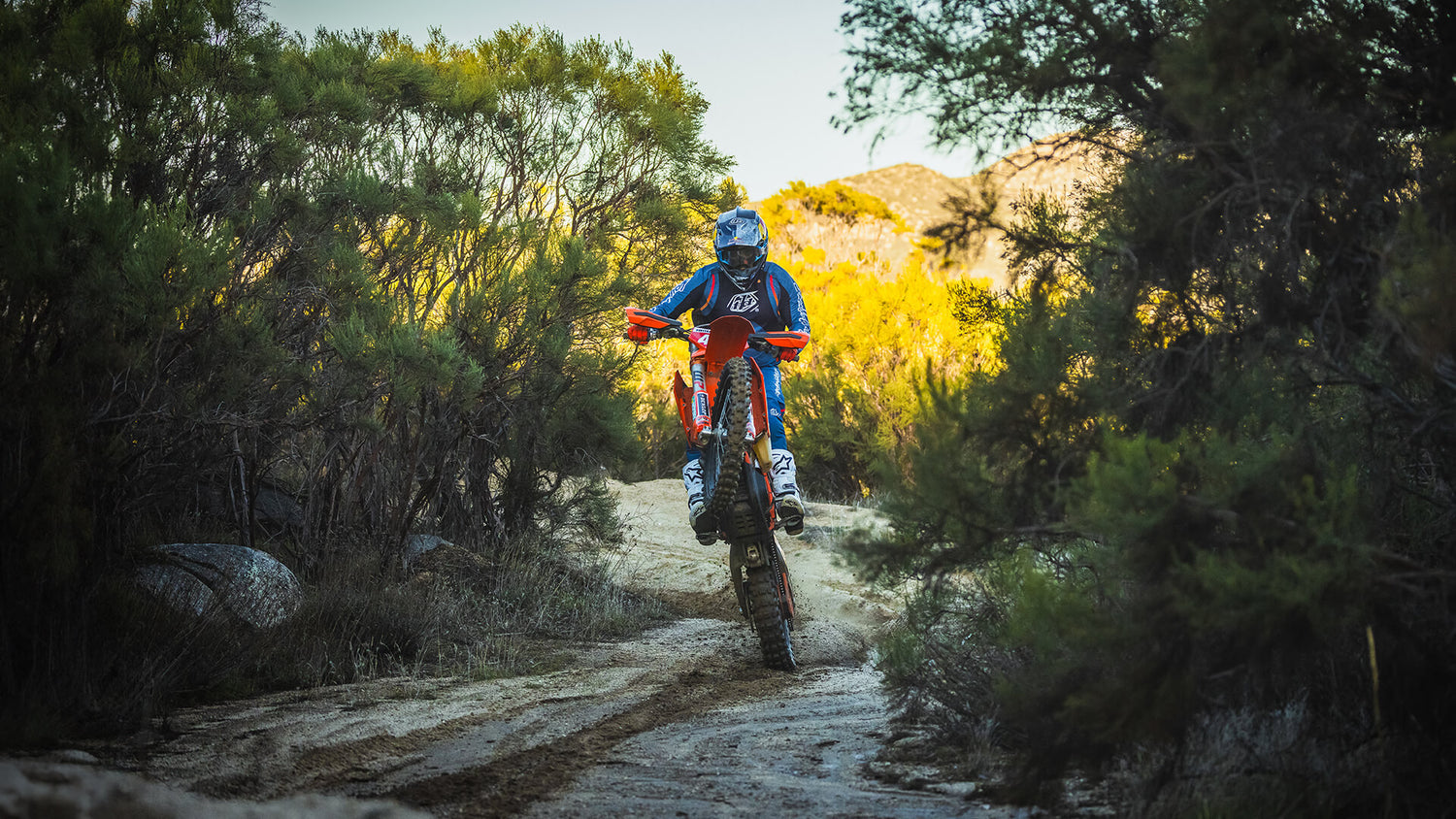 Motocross off road rider going through water