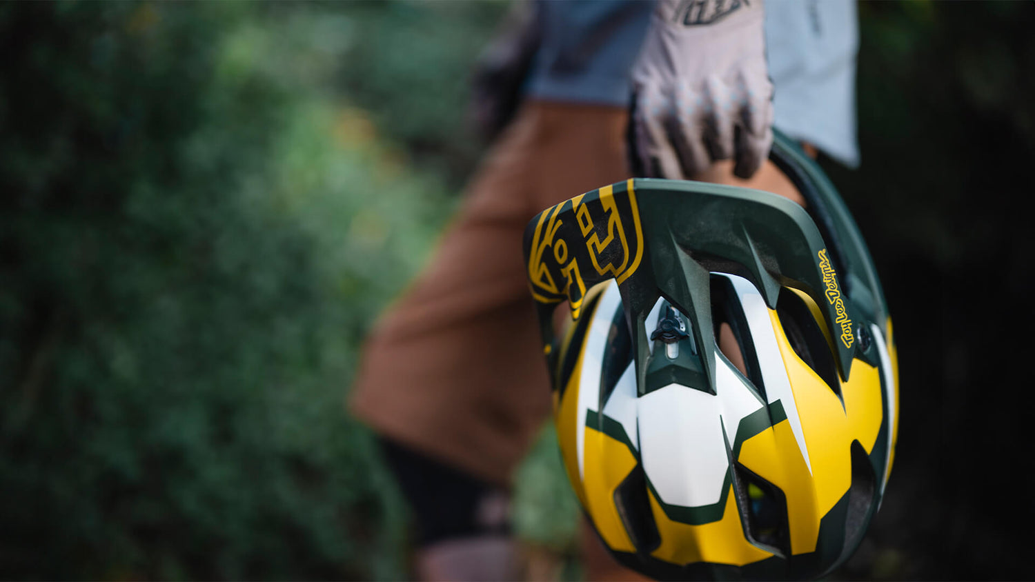 Troy Lee Designs rider holding the Stage helmet